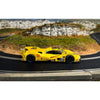 Scalextric C4653 yellow Porsche 963 No. 85 JDC Miller Daytona 2025 1:32 slot car, side view on a slot car track