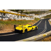 Scalextric C4653 yellow Porsche 963 No. 85 JDC Miller Daytona 2025 1:32 slot car, rear three-quarter view on a slot car track